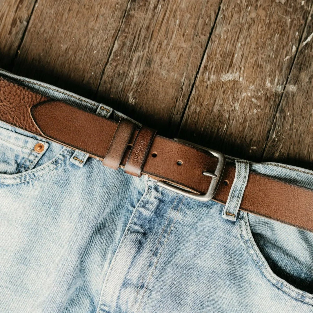 Brown leather belt on a pair of light blue jeans against a wooden background Belts belt-morphett-1 indepal-leather.myshopify.com