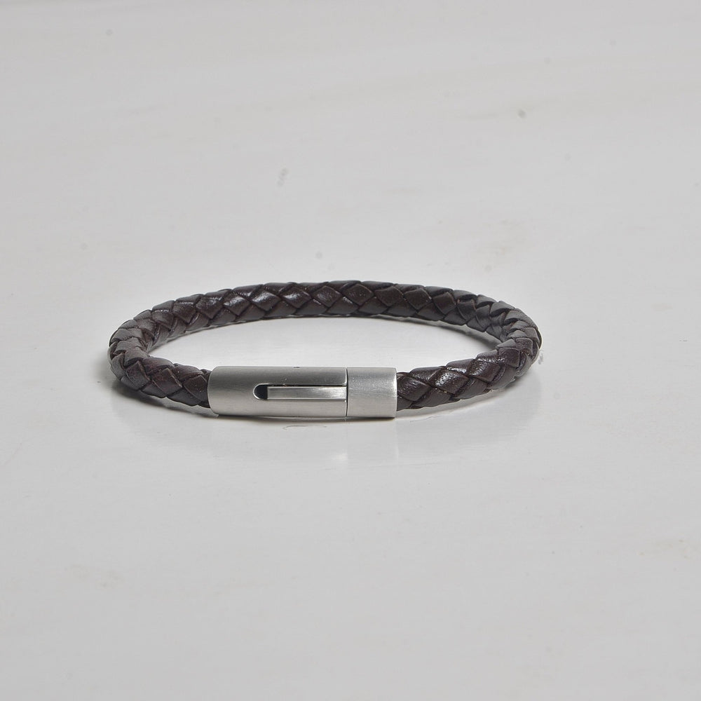Bracelet with a metallic clasp on a light gray background
