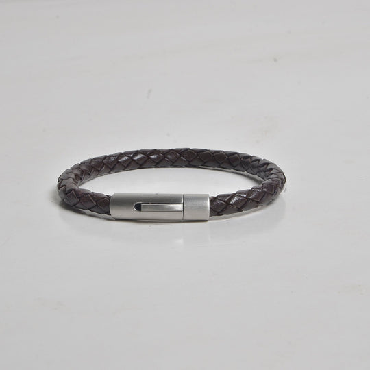 Bracelet with a metallic clasp on a light gray background