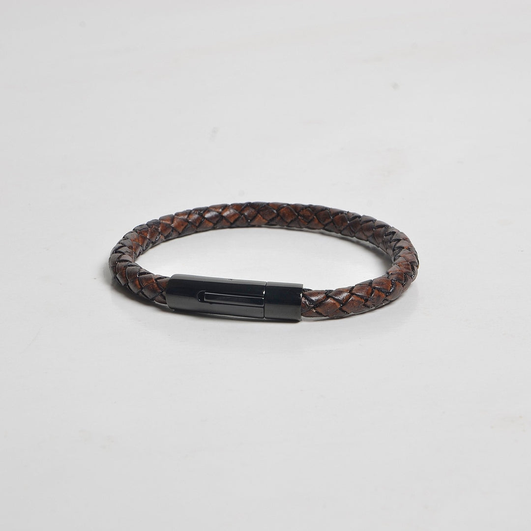 Brown braided leather bracelet with a black metal clasp on a light gray background
