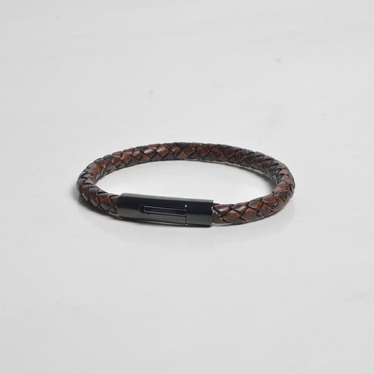 Brown braided leather bracelet with a black metal clasp on a light gray background