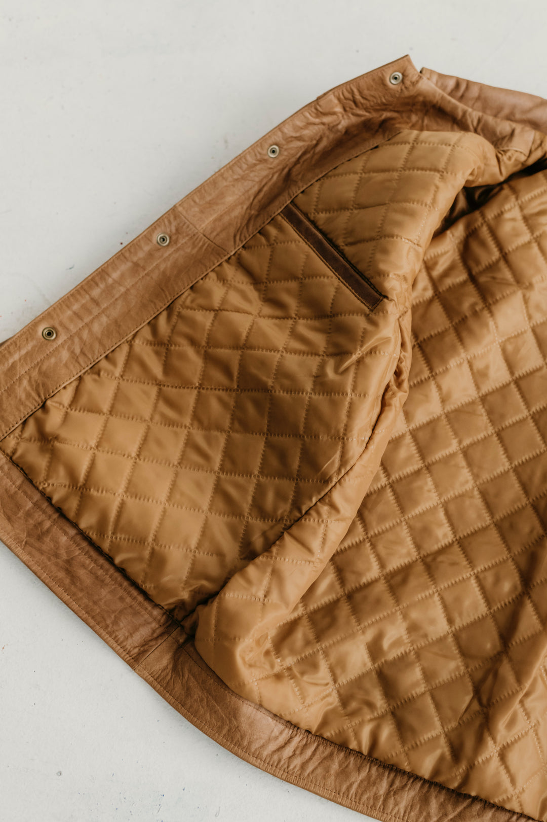 Close-up of the inner quilted lining and pocket of the Hailwood Raw Beige Leather Jacket by Indepal Leather from Bolt + Buckle.