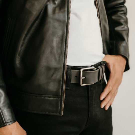 Close-up of the Ollie Black Leather Jacket by Indepal Leather from Bolt + Buckle, showing texture, zipper, and belt styling detail.